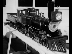 A beautiful Illinois Central 4-4-0 "Fire Queen" built by Bill Van Brocklin and owned by Elmer Roth as of 1995. It feaures a coal fired copper boiler, 2 injectors, 2 cyl. steam water pump, 2 injectors, mech. oiler, whistle,hand pump and hydraulic brakes on the tender. She was rebuilt in 1995 by Elmer. From TrainNet.org.