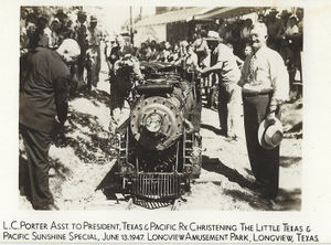 L. C. Porter, Assistant to the President of the Texas & Pacific Railway, christening The Little Texas & Pacific Sunshine Special, June 13, 1947, Longview Amusement Park, Longview, Texas.