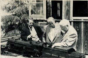 Left to right, Dave Rose, Les Friend and Dick Jackson examine Bob Day's 1 inch scale Hudson type J locomotive at Bob's home.