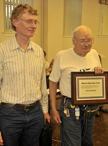 Clint Ensworth Jr. holds his certificate of appreciation while standing with his son, Clint Ensworth III,, during the July 23, 2010, Akron Railroad Club meeting.
