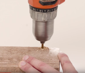 Creating a jig from wood block and drill bit for rounding linkage corner.