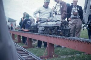 Unknown location, locomotive and people. From eBay, August 2020. Seller stated the slide had red border, placing its date in the 1950's.