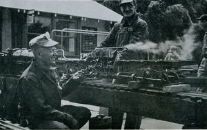 Gordon Corwin of Southern California Live Steamers at the Golden Gate Live Steamers Spring Meet, 1956, feeding steam from his locomotive to the engine of his Shay with the able assistance of Louis Lawrence. Photo by Harry Dixon. From The North American Live Steamers, Vol 1 No 5, 1956.