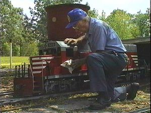 John Cassady polishing his Railroad Supply GP-40 at his Possum Flats & Eastern RR.