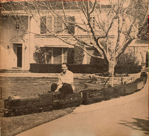 Dave Rose's railroad completely circles his home in the San Fernando Valley. In this photo brother Harry Rose caught the train passing through a section of the front yard. From The Miniature Locomotive, September-October 1954.